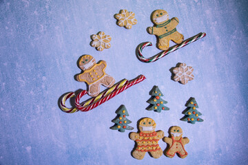 Gingerbread men comply with the social distance during the practice of winter sports. horizontal orientation