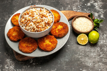 front view delicious fried cutlets with cooked rice on dark background dish rissole meat