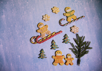 Gingerbread men are engaged in winter sports and observe social distance. horizontal orientation