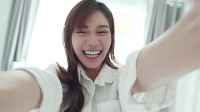 SLOW MOTION Tracking In Asian Woman With A White Shirt Spins Frottage Feel Good With A Selfie Video