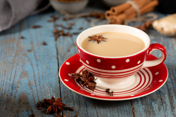 Masala tea. Indian masala tea in a cup with spices on a blue background. Traditional indian drink