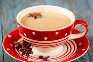 Masala tea. Indian masala tea in a cup with spices on a blue background. Traditional indian drink