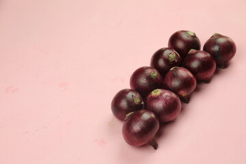 sweet red onions on background