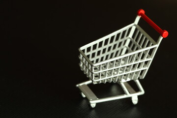 Miniature shopping cart model scene represent online shopping and retail business concept related idea.