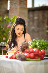 country life. An Italian woman eats dinner and pasta in her home garden