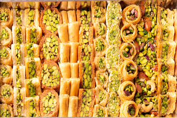 mix baklava tray or baklawa is arabic and turkish traditional sweets with pistachio , top view
