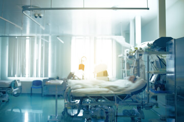Defocused emergency room with blinding light over a patient on the gate as a life and death concept