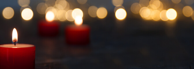 Christmas candle light with blurred golden bokeh for religious ritual and funeral service or...