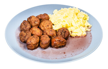 cooked swedish meatballs with lingonberry sauce and mashed potatoes on blue plate isolated on white background