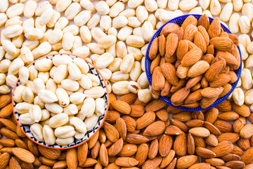 Almonds and hazelnuts in the bowl, beer and healthy snack