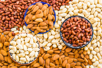 Almonds, peanut and hazelnuts in the bowl, beer and healthy snack