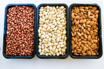 Almonds, peanut and hazelnuts in the bowl, beer and healthy snack