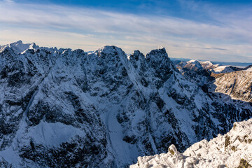 A fragment of the Main Ridge of the Tatra Mountains in the snow rime on a beautiful sunny and frosty day. Among the peaks, among others, Mieguszowiecki Summits.