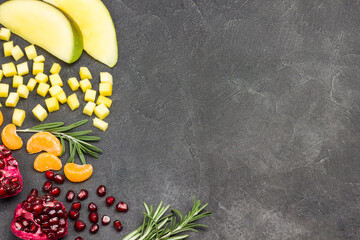 Still life of mango, pomegranate on black background