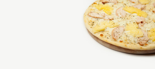 Texture Delicious Hawaiian pizza served on a wooden plate, ingredients garlic sauce, mozzarella cheese, smoked chicken, canned pineapples on white. Pizzeria promotion poster.