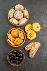 top view delicious sweet cakes with cookies and olives on dark background pie cake sweet