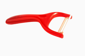Red ceramic peeler isolated on white background. Close-up
