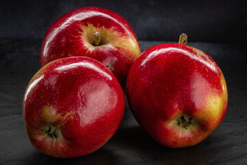 Three juicy red apples close-up