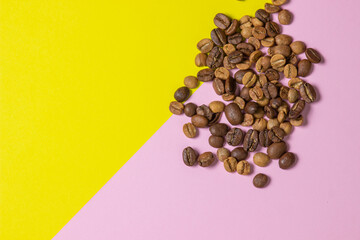 Coffee beans on a geometric background. Colored background. Background for design, lettering or logo. Different roasted coffee beans