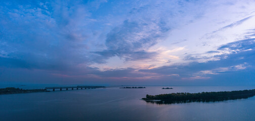 Aerial view from drone over of the beautiful big river in the autumn with islands. Sunset blue time. Beautiful fall nature travel background.