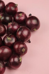 sweet red onions on background