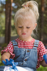 Two little girls sisters paint with finger paints