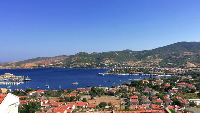 Aerial view of a fisher town called Foca and time lapse of seabus or public transportation leaving the town.