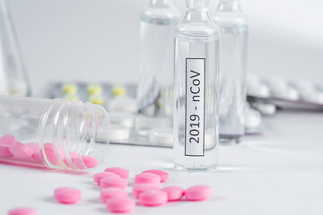 Covid vaccine surrounded by different types of pharmaceuticals