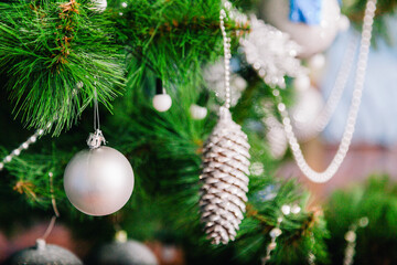 Christmas tree decorated with white and blue balls with bows