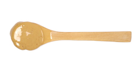Peanut butter with wooden spoon isolated on white background, top view