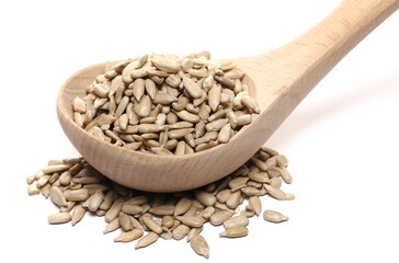 Peeled sunflower seeds in wooden ladle, spoon isolated on white background