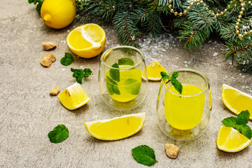Traditional homemade lemon liqueur limoncello with fresh citrus and mint
