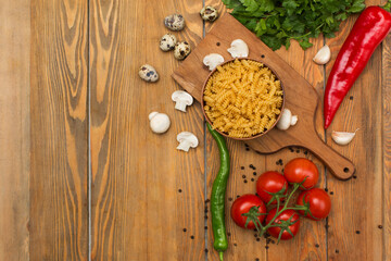 Raw pasta and vegetables broccoli, tomatoes, peppers, garlic and mushroom