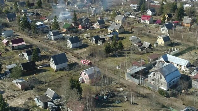 Fire truck rides a country road to extinguish a fire. Aerial view
