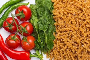 Raw pasta and vegetables broccoli, tomatoes, peppers, garlic and mushroom