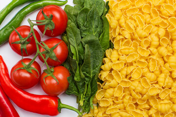 Raw pasta and vegetables broccoli, tomatoes, peppers, garlic and mushroom