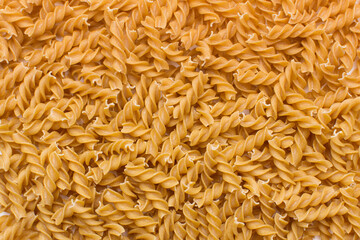 Many raw brown fusilli in jar in studio