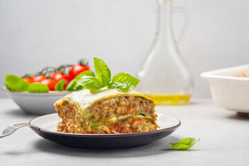 Homemade oven-baked green lasagna - Lasagne alla bolognese with spinach in the dough, ragu - meat sauce, bechamel and parmesan cheese. Italian food.  Horizontal image.