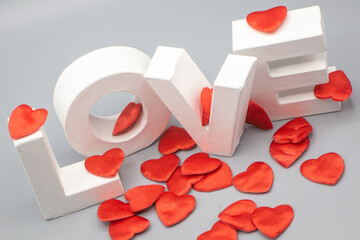 close up Word love with 3d letters and grey background plus red hearts