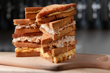 stacked stack of sandwiches on a chalkboard with various ingredients.