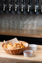 Nachos, corn chips on plate. Wooden background. Copy space. Menu for restaurant