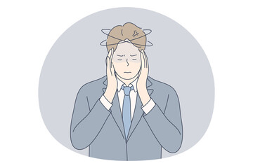Stress, overwork, overload concept. Unhappy depressed stressed young businessman office worker touching head with fingers, feeling headache, stressed and tired in office. Exhaustion, depression 