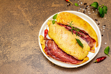 Raw duck breasts with fresh greens and fragrant spices