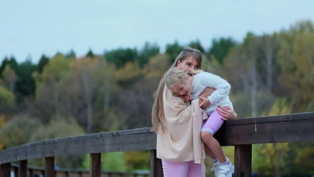 girl with her mom, mother with daughter spends time together. happy family spends time together in the park. relationships between generations. Slow motion video. stock footage