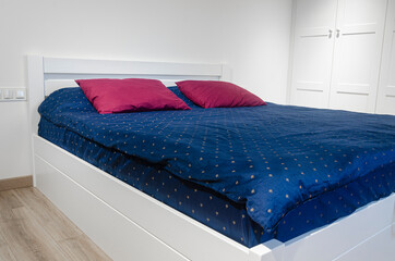 Scandinavian style. White bedroom with bright Scandinavian bedding