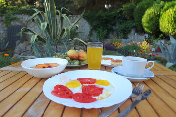 Breakfast with scrambled eggs, fruit and orange juice