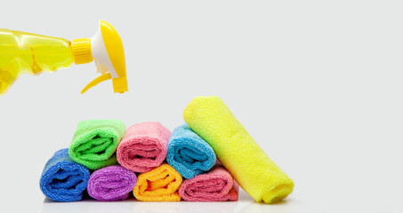 Microfiber cleaning cloth and cleaning spray bottle. colorful microfiber towels isolated. rolled textile cloth, colorful. Domestic household cleaning service and articles concept. Copy space panoramic