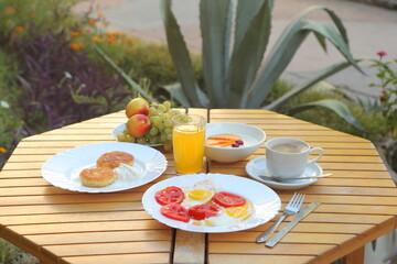 Breakfast with scrambled eggs, fruit and orange juice