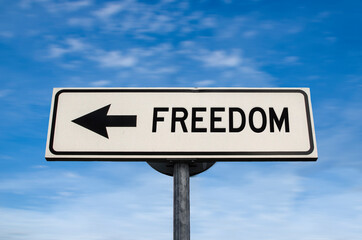 Freedom road sign, arrow on blue sky background. One way blank road sign with copy space. Arrow on a pole pointing in one direction.