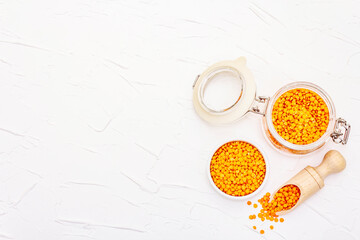 Dry orange lentils in glass jar